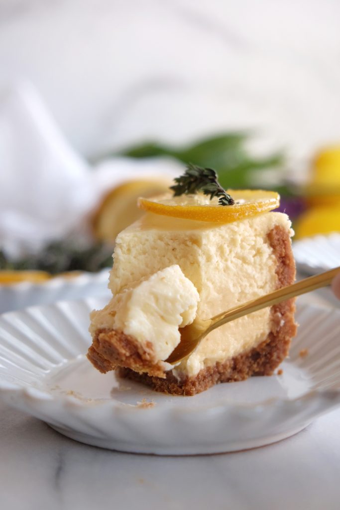 A spoon scooping lemon cheesecake