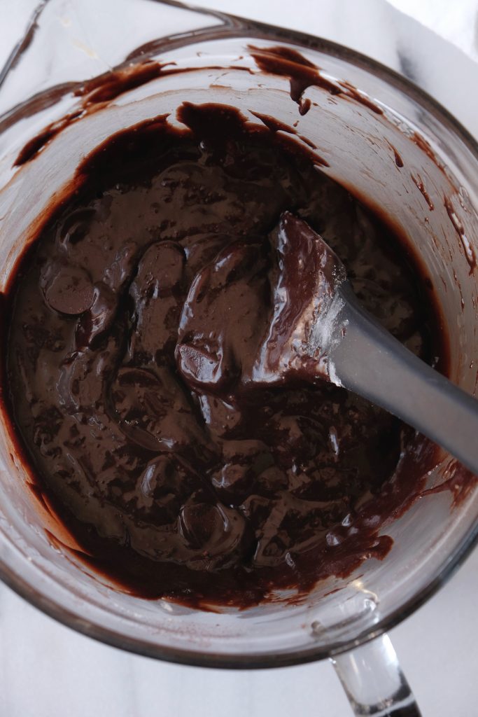 Double chocolate brownie batter in a glass mixing bowl, all ingredients mixed and folded