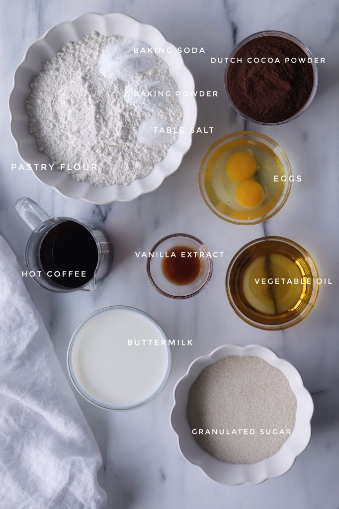 All ingredients for the chocolate cake, placed in individual prep bowls
