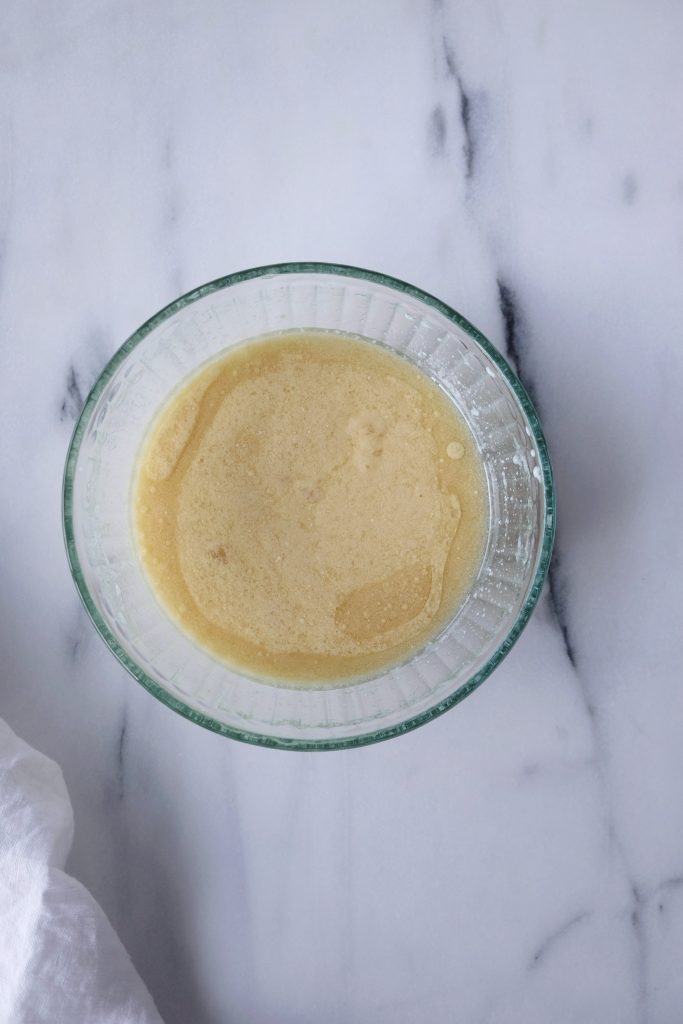 Glass bowl with buttermilk, vegetable oil eggs, vanilla extract; mixed to combined