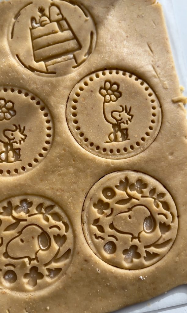 Sheet of Piemonte hazelnut cookie dough stamped with characters from Peanuts